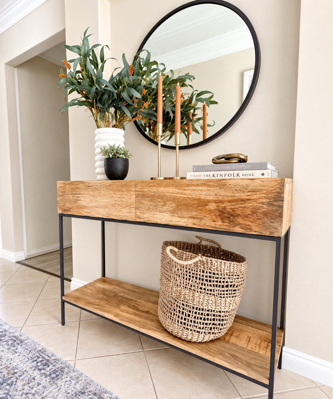Entry console with round mirror, candlesticks and styled greenery
